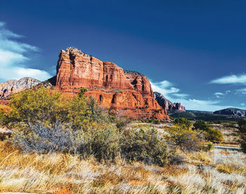 Rock formations on landscape against sky