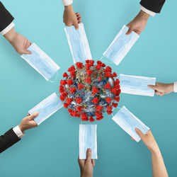 Midsection of people holding umbrella