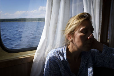 Portrait of young woman sitting on a boat