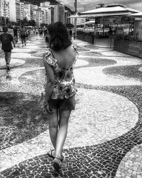 Full length of woman walking on street in city