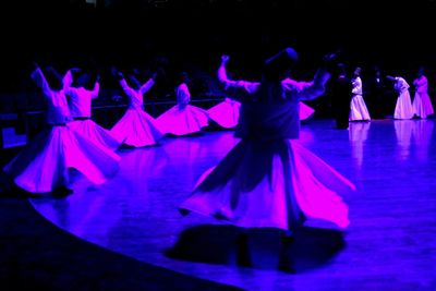 Group of people on purple at night