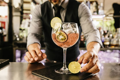 Bartender making drink at bar