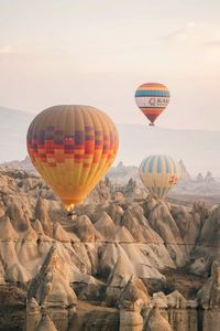 Hot air balloons flying against sky