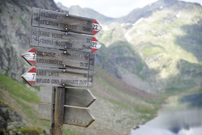 Close-up of information sign against mountain