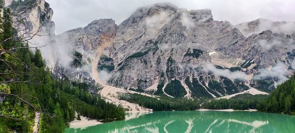 Panoramic shot of lake and snowcapped mountains against sky