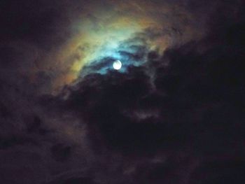 Low angle view of cloudy sky at night