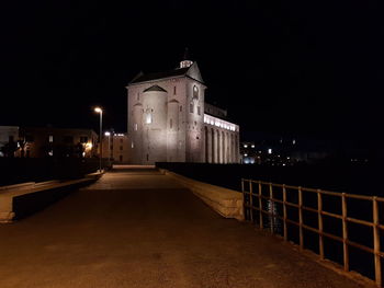 Illuminated building against sky at night