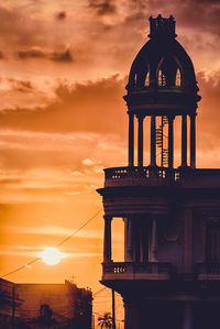 View of tower in city during sunset