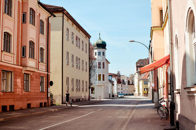 Street amidst buildings in city against sky