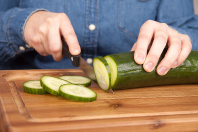 Close-up of person preparing food on cutting board