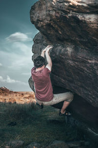 Full length of woman on rock formation against sky