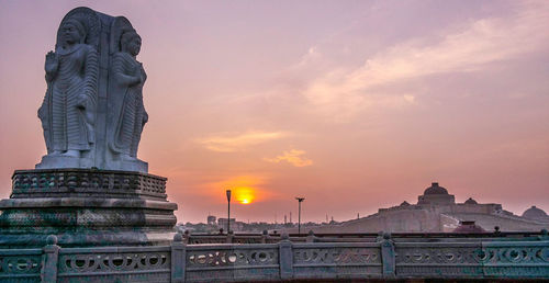 Low angle view of built structure against sunset sky