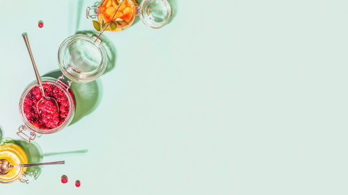 Red berries on glass against white background