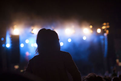 Rear view of woman at music concert