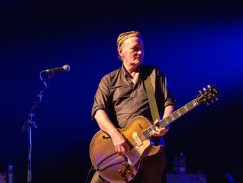 Man playing guitar at music concert