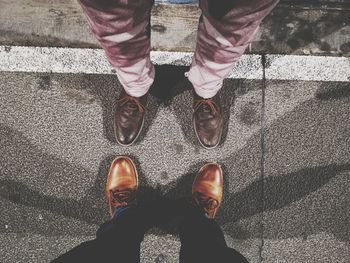 Low section of man standing on footpath