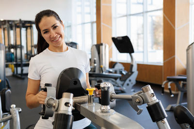 Portrait of young man exercising in gym