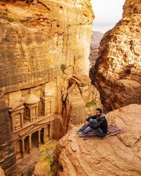 Woman sitting on rock