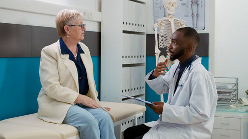 Female doctor examining patient in hospital