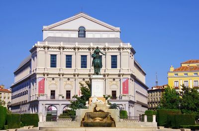 Statue against sky in city