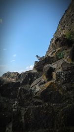 Low angle view of rock formation against clear blue sky