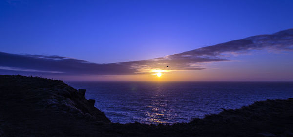 Scenic view of sea against sky at sunset