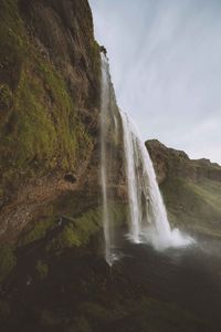 Scenic view of waterfall against sky