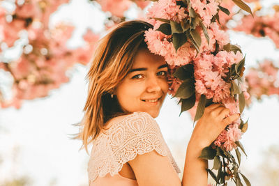 Portrait of beautiful woman with flowers