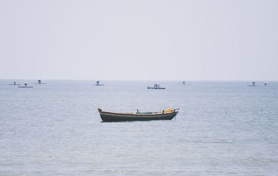 Sailboat in sea against clear sky