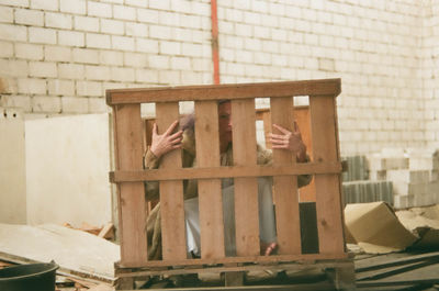 Low section of person against wall in building