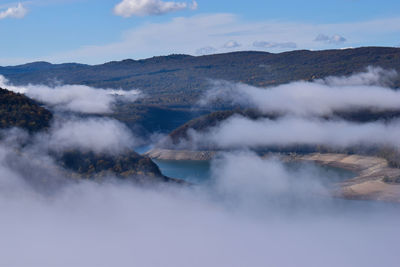 Smoke emitting from volcanic mountain against sky