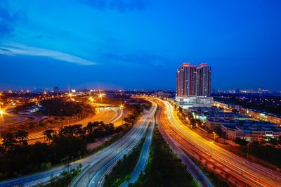 High angle view of light trails on highway at night