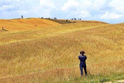 Woman standing on grassy field