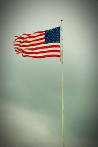 Low angle view of flag against sky