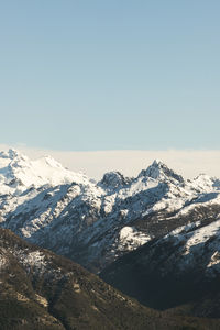 Scenic view of snowcapped mountains against clear sky