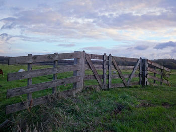 Wooden structure on beach against sky