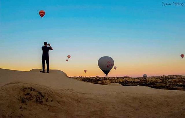 leisure activity, lifestyles, clear sky, copy space, men, full length, sunset, mid-air, sport, sky, adventure, hot air balloon, tranquil scene, standing, scenics, beach, sea, parachute