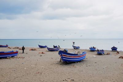 Boats on beach against sky