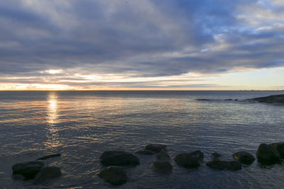 Scenic view of sea against sky at sunset