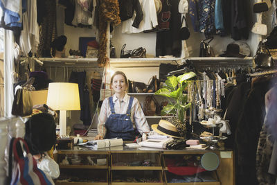 Caucasian female owner standing at counter in boutique