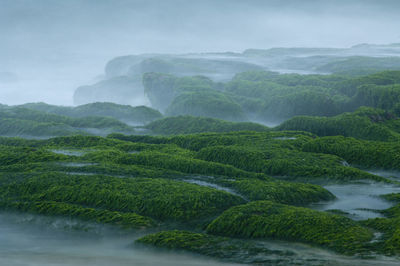 Scenic view of waterfall against sky