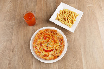 High angle view of pizza served on table