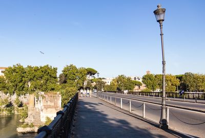Street by road against sky in city