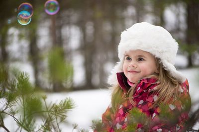 Girl smiling while looking at bubbles