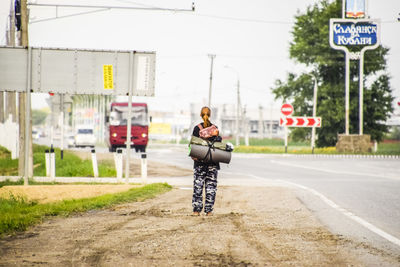 Rear view of woman walking on road