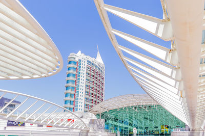 Low angle view of modern buildings against blue sky