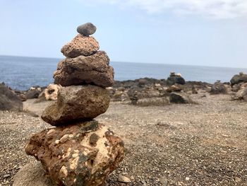 Stack of rocks on shore against sea