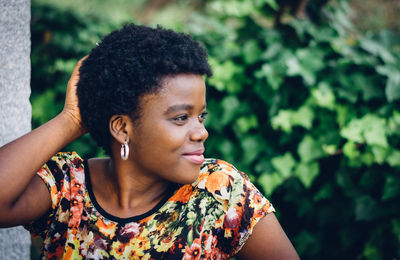 Close-up of young woman against tree