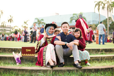 Portrait of people sitting outdoors