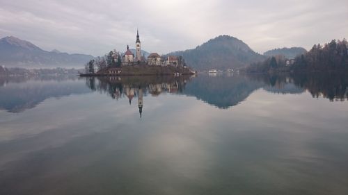 Scenic view of lake and mountains against sky